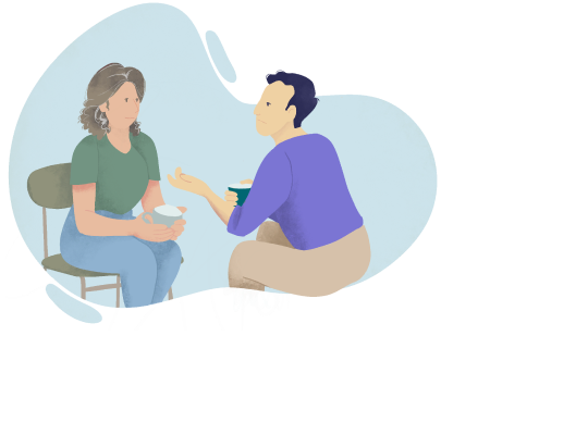 Un homme et une femme, aidants de leur proche dépendant, sont assis avec un café et discutent.
